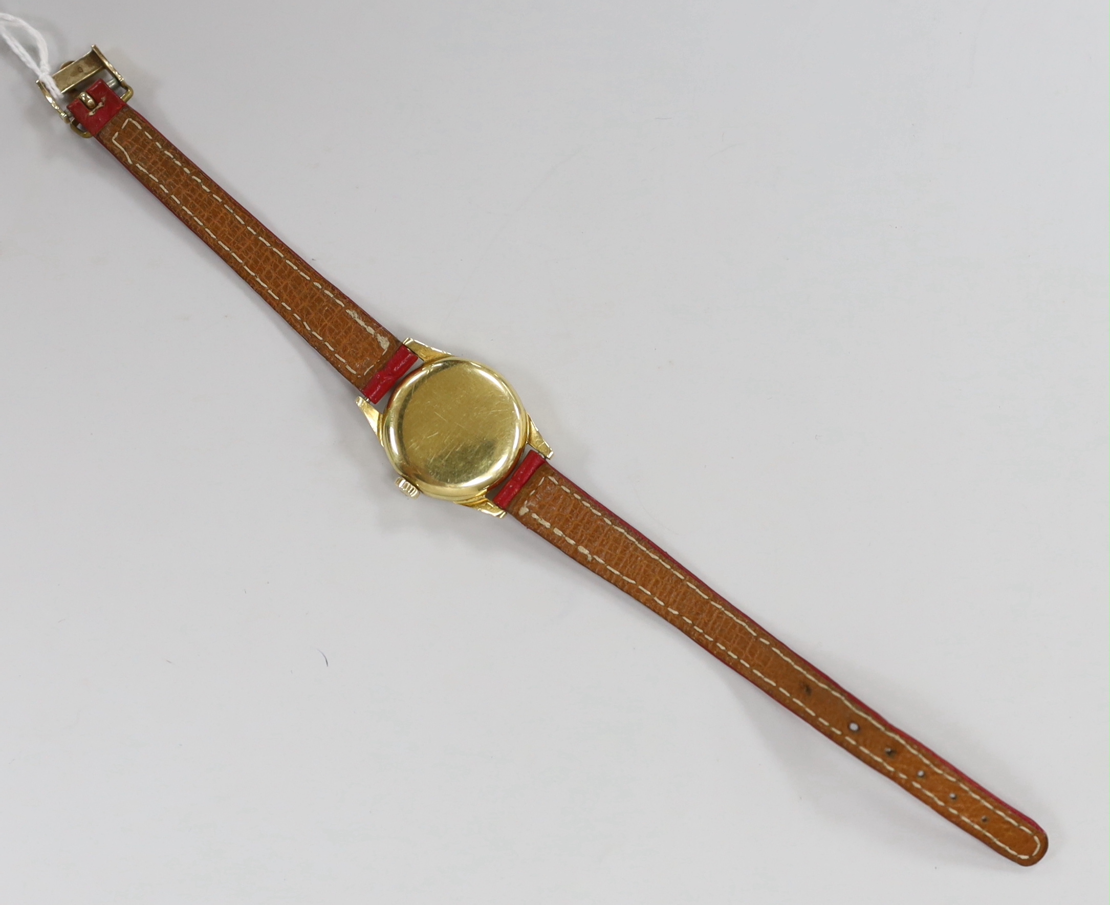 A lady's 18k Omega manual wind wrist watch, on a leather strap with 9ct gold buckle with Omega insignia, gross weight 15.9 grams.